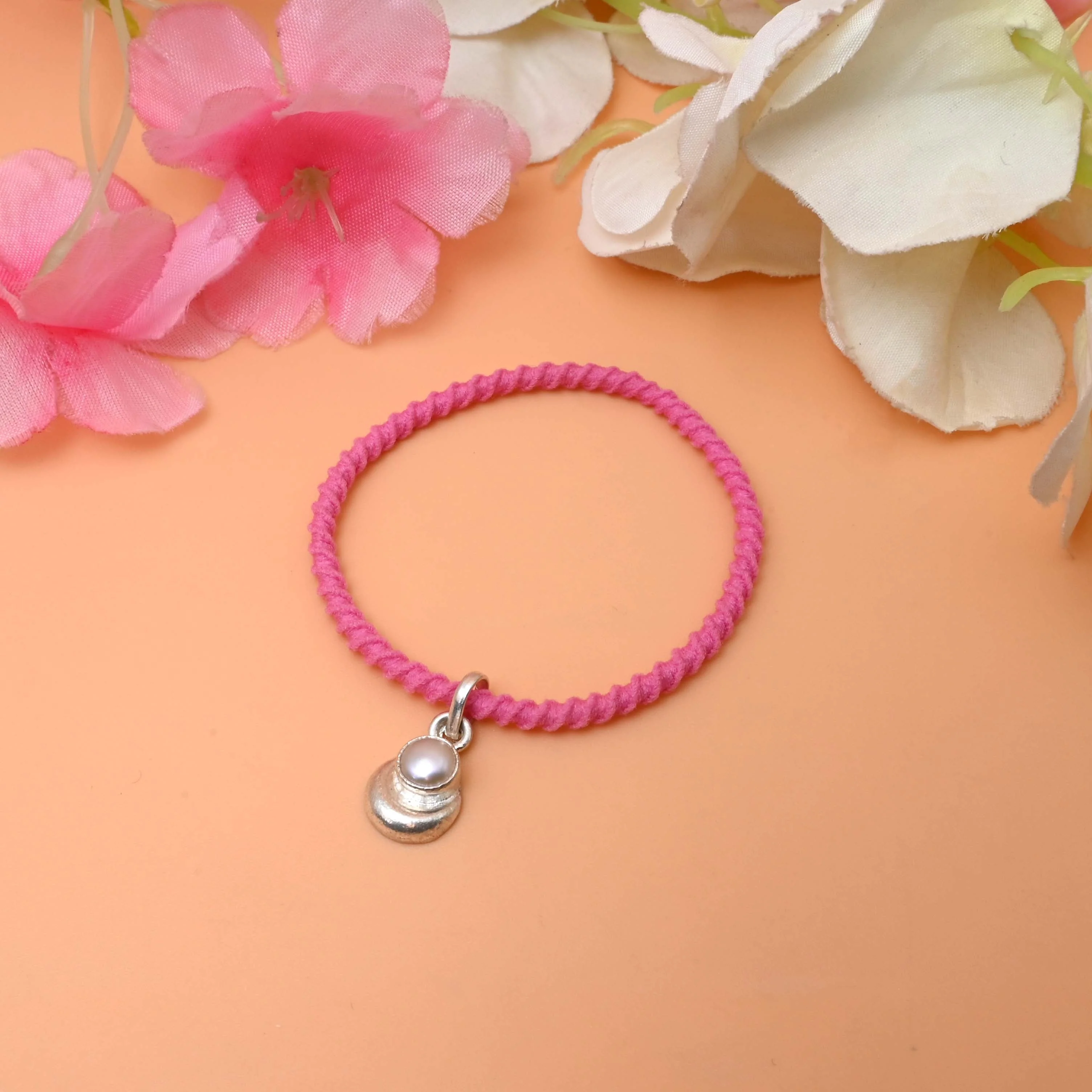 A string bracelet featuring a delicate silver charm - Image 2