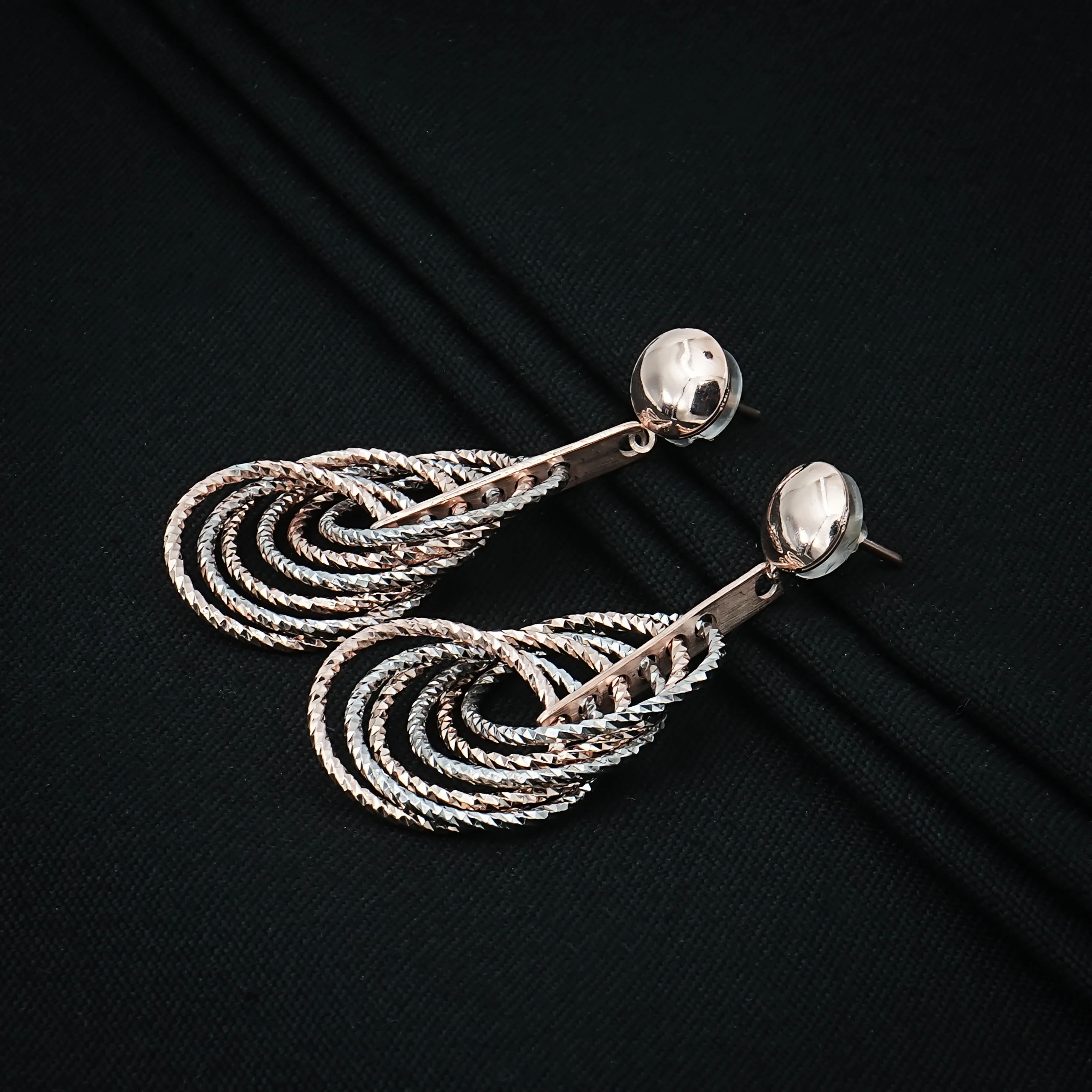 Layered Teardrop Silver Dangle Earrings with a Unique Textured Pattern - Image 2