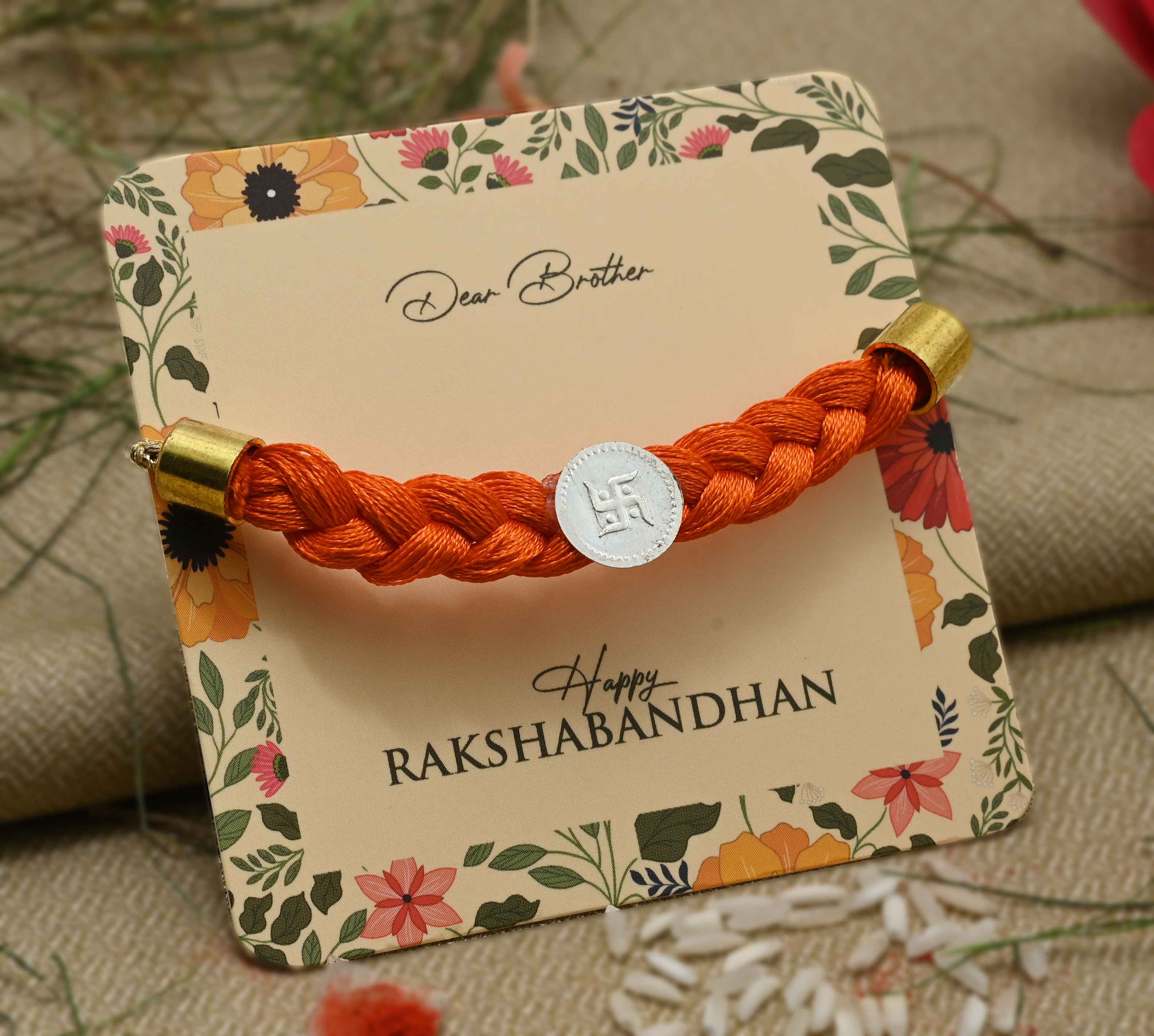 Silver Center Swastika with Orange Tangle Moli Rakhi for Boys