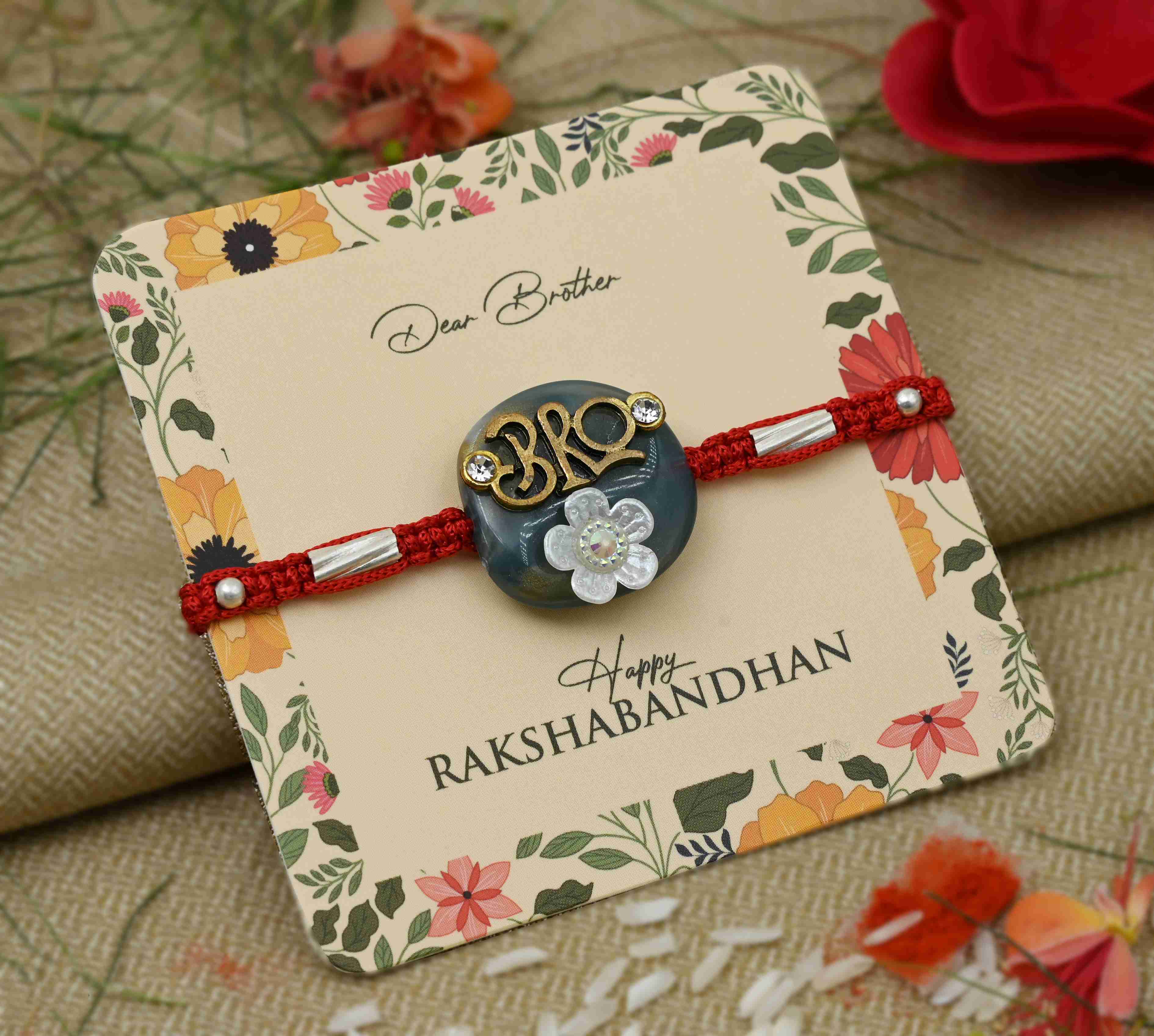 Silver Center Written Bro Blue Background with White Flower Rakhi for Boys